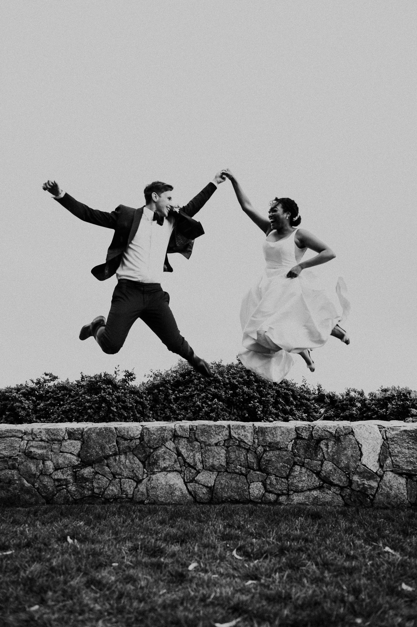 Wind-and-Sea-Wedding-bride-groom-jumping-overlooking-Pacific-Ocean