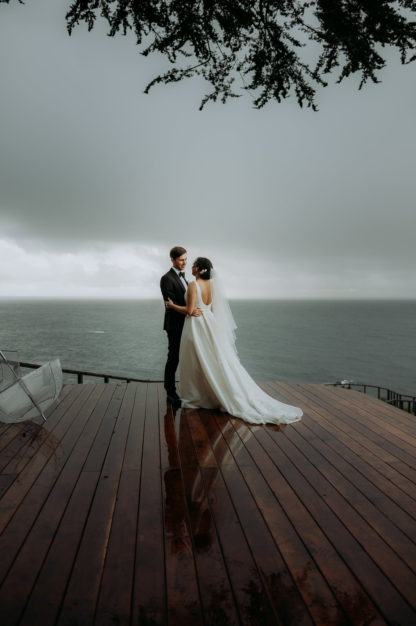 Wind-and-Sea-Wedding-bride-groom-on-deck-overlooking-Pacific-Ocean