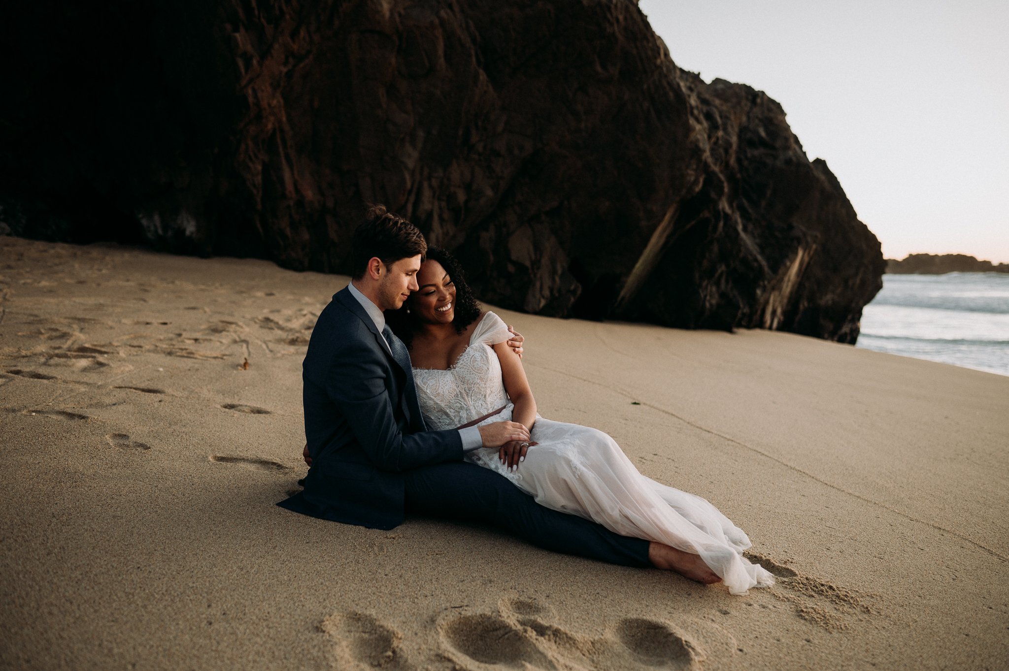 Big-Sur-Beach-Bride-Groom-sitting-in-sand-sunset