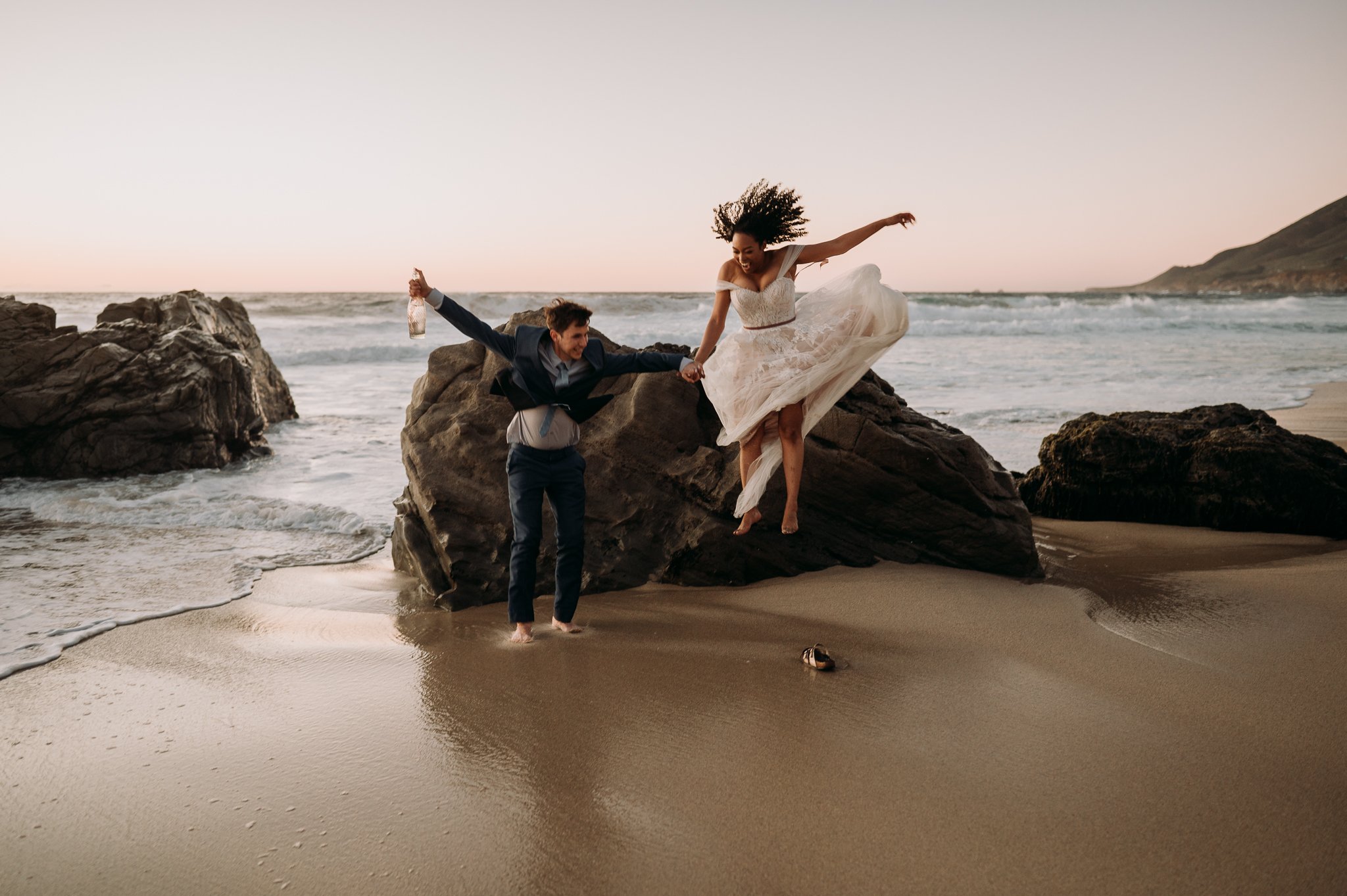 Big-Sur-Beach-Wedding-Celebration-jumping-off-rock