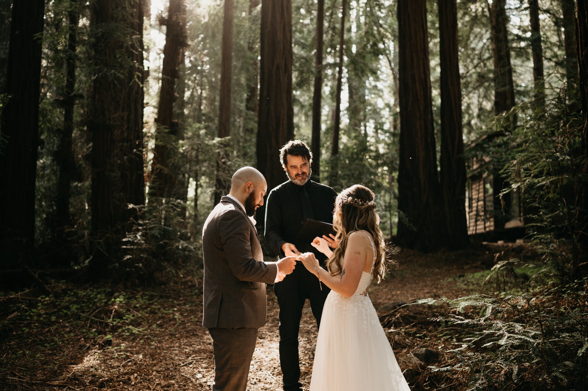 Glen Oaks Big Sur elopement ceremony the bride groom and officiant under redwood trees