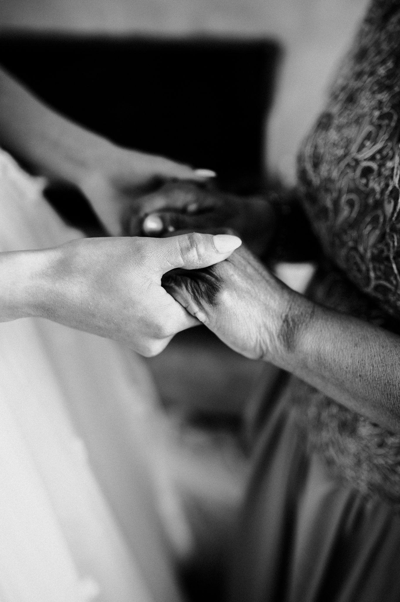 black and white photo of bride and mother's hands 