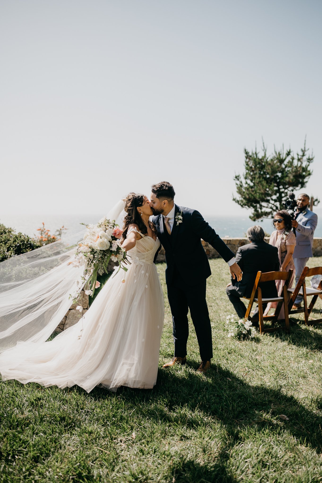 bride and groom share a kiss after ceremony Big Sur wedding