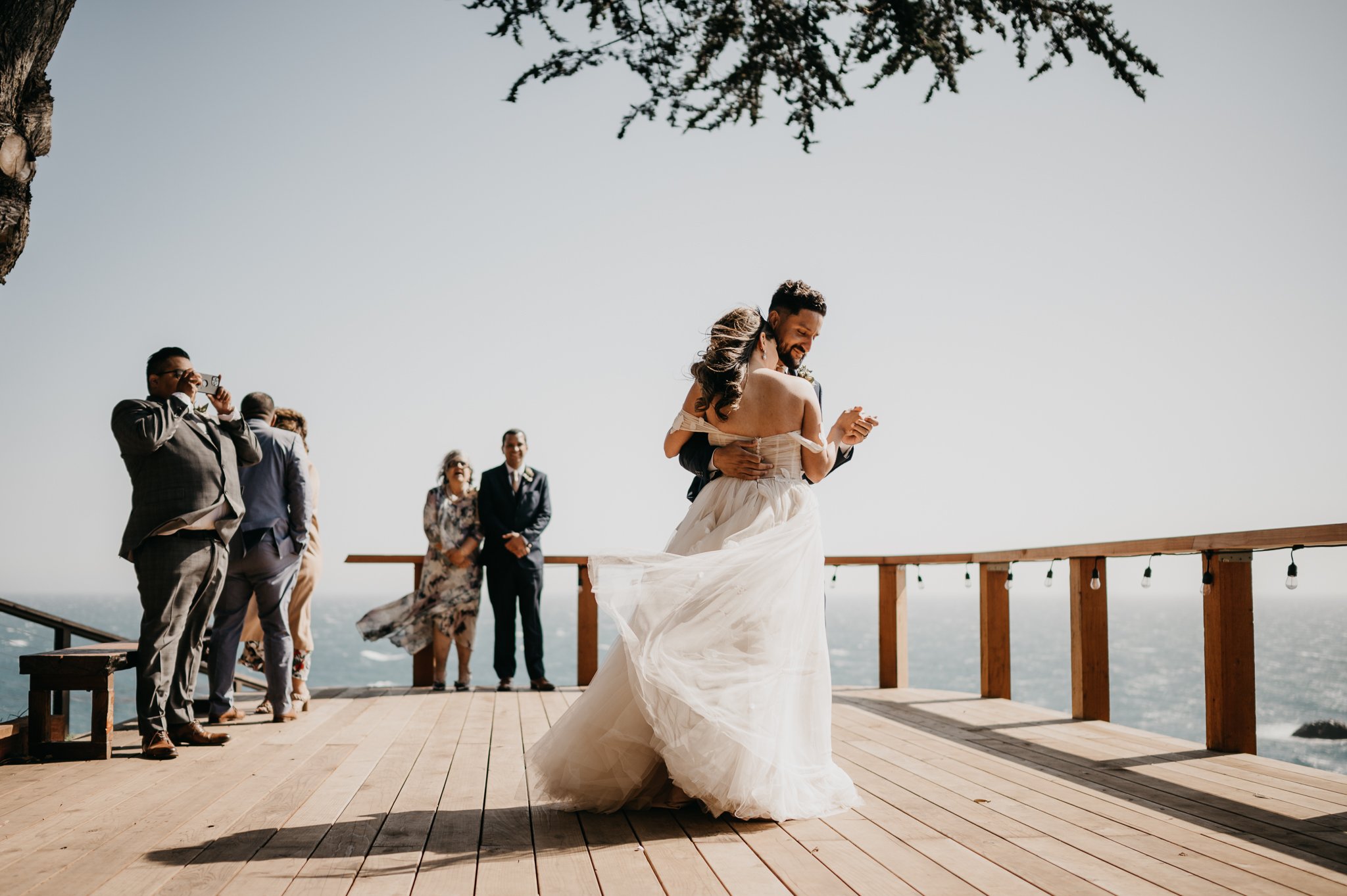 Bride and groom first dance on deck at Wind and Sea Big Sur