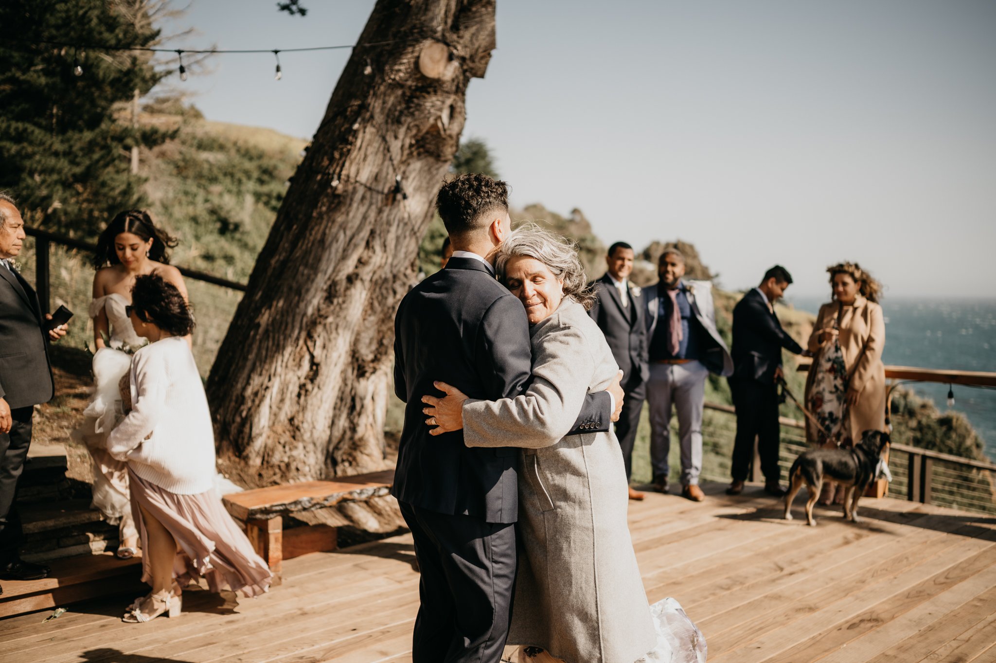 Groom and mother dance on deck in garden at Wind and Sea Big Sur