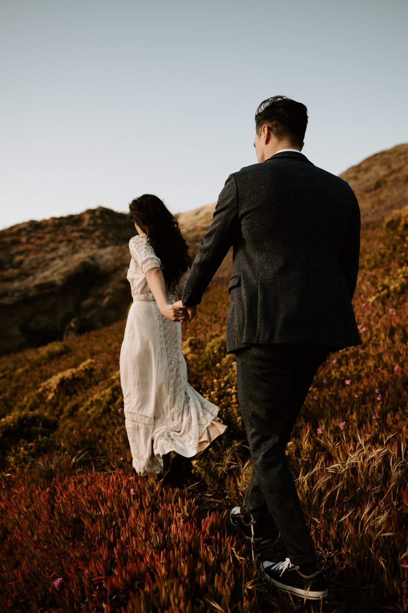 Couple walking on path in Big Sur with woman leading the man 