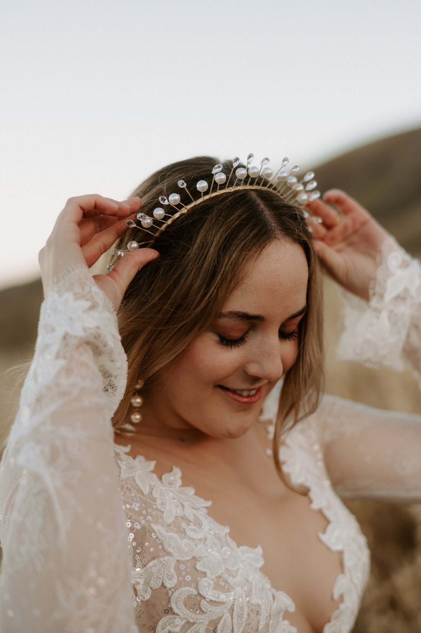 upper body of bride adjusting her beaded crown, Big Sur wedding