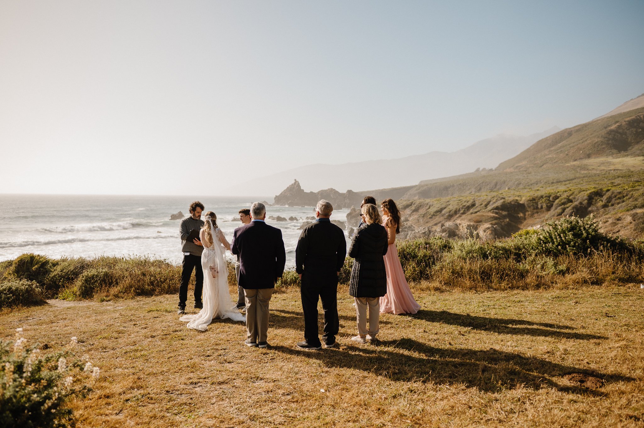 wedding ceremony on cliffside in Big Sur with family and friends