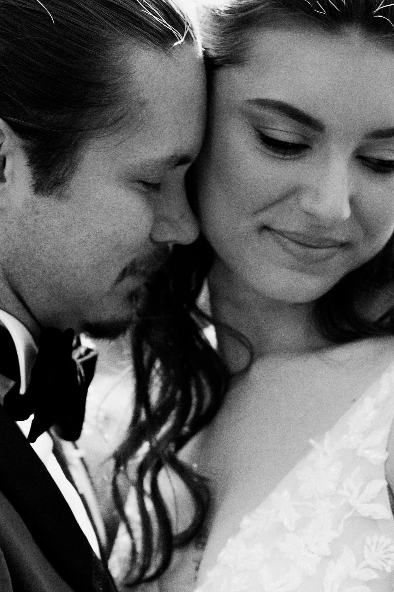 black and white close up of bride and grooms faces 