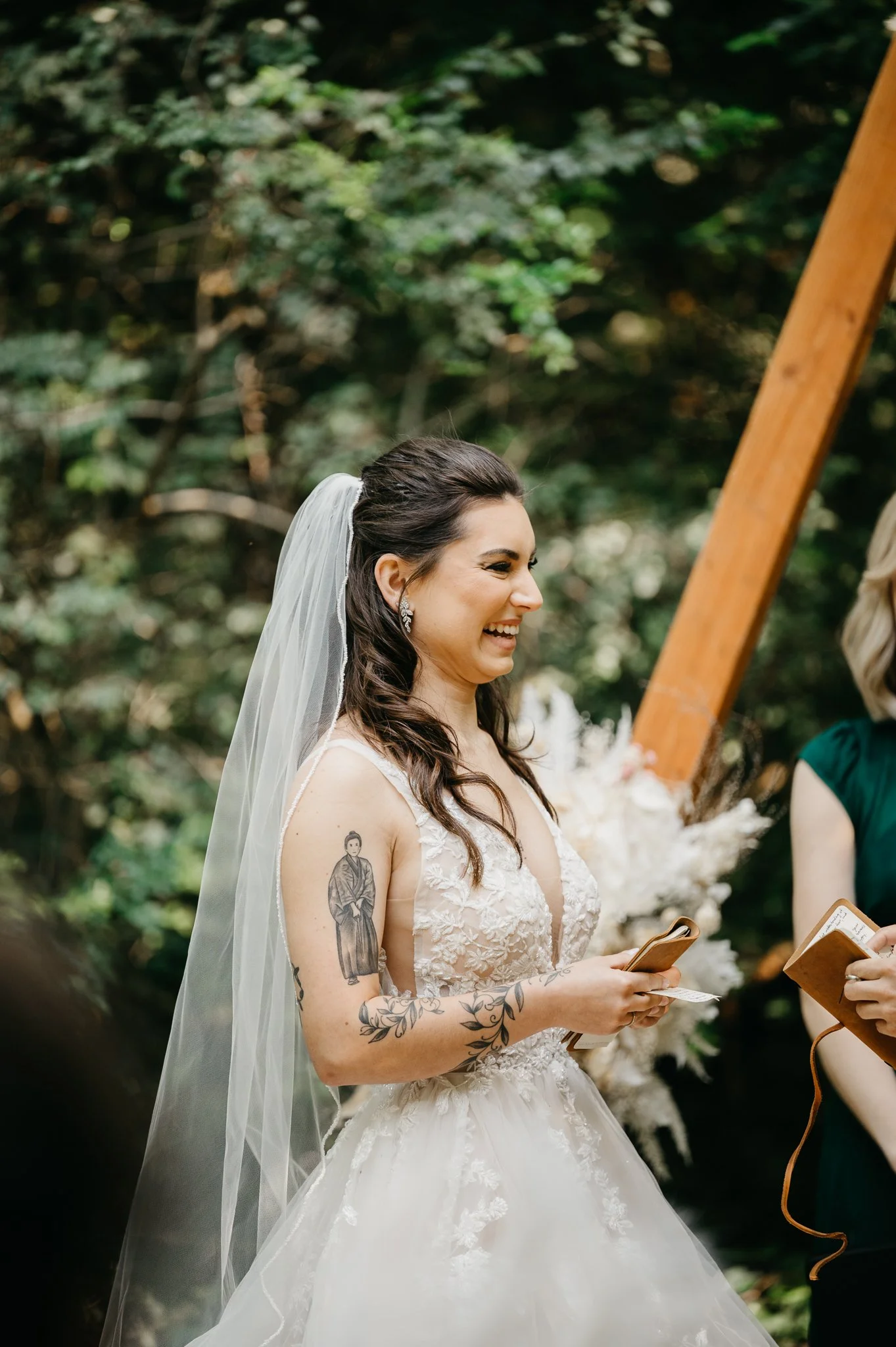 Big Sur Wedding bride at alter during ceremony laughing under trees