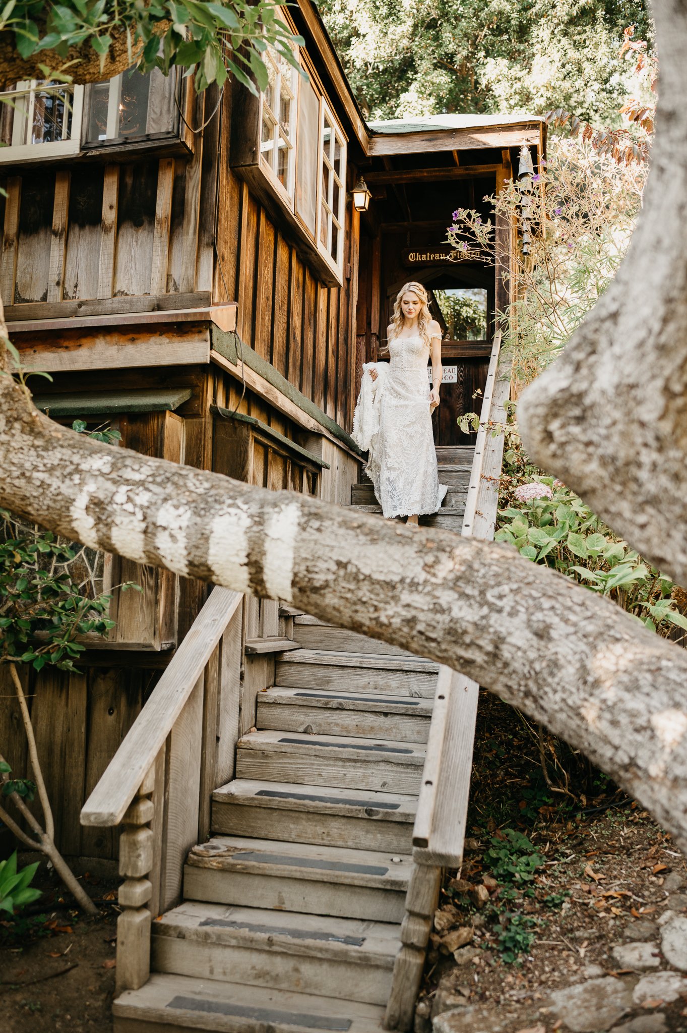 bride in wedding dress coming down stairs to meet groom at Deetjen's Big Sur