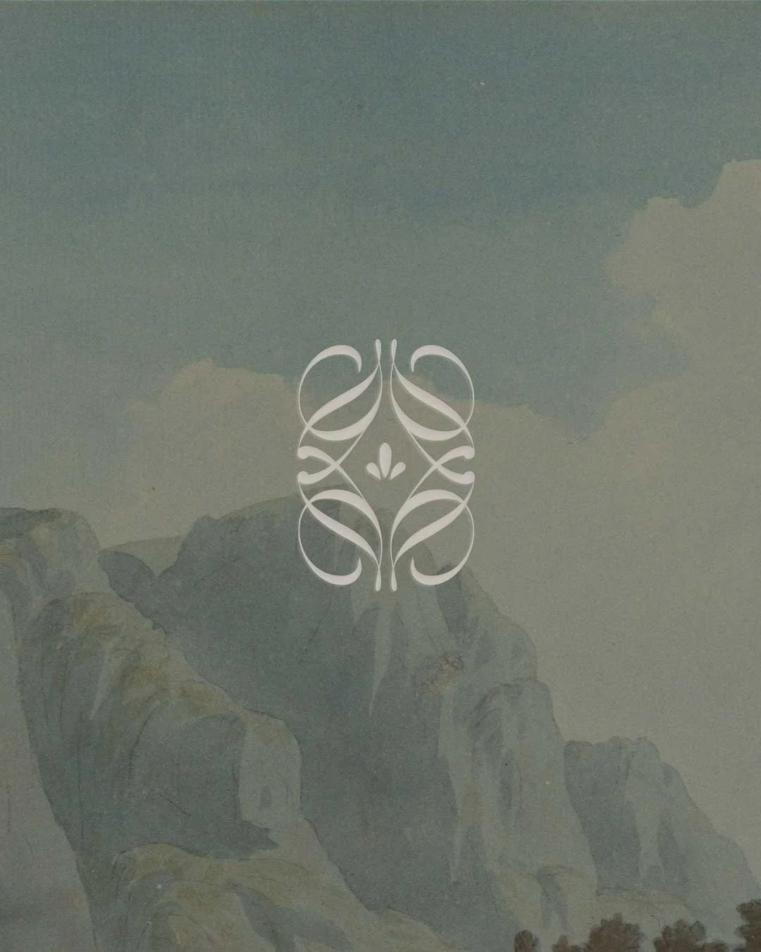 A scenic mountain landscape with foggy clouds and rocky peaks, overlaid with a white decorative symmetrical design in the center.
