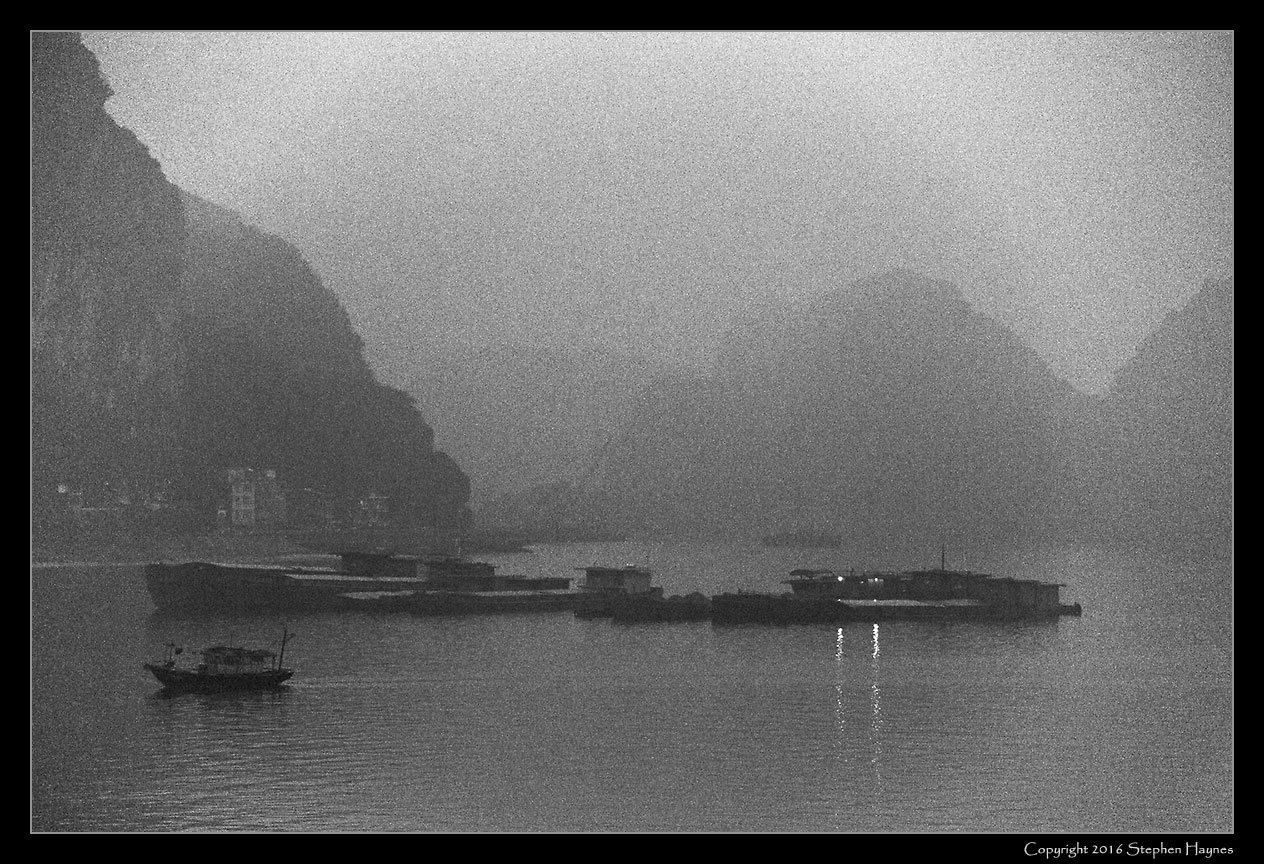 Halong Bay, Vietnam --
Halong Bay seen in early morning. Grain introduced to mask high ISO noise.