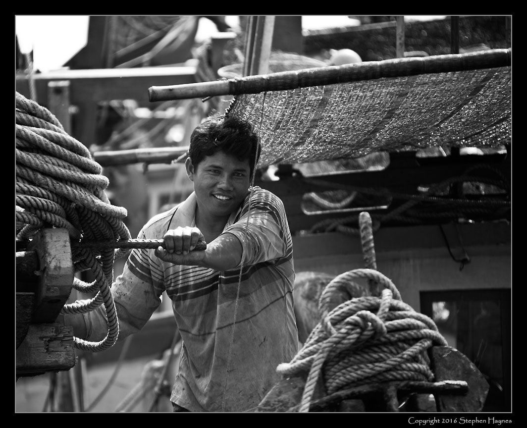 Ropang Ropov Fishing Village, On the road east from Sihanoukville, Cambodia --
A friendly and welcoming smile. Our visits to these places were always brief, so there was
never time to try to get to know my subjects better.