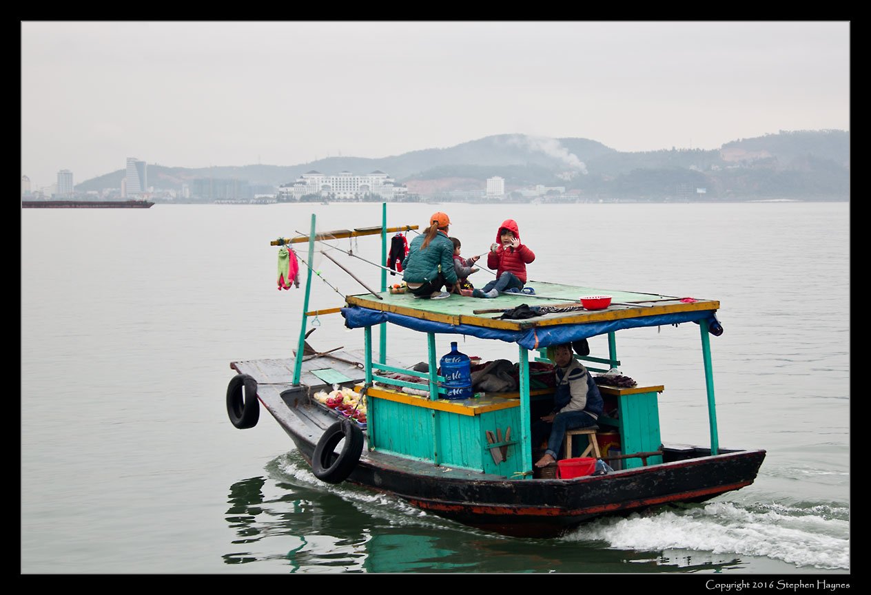 Halong Bay, Vietnam --
Departing after having made no sales. A friendly goodbye wave nonetheless.