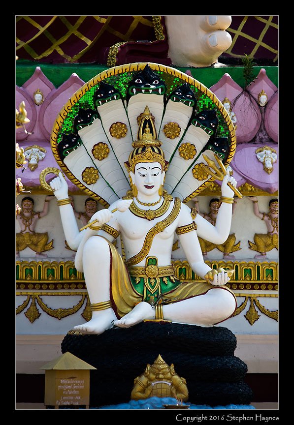 Koh Samui, Thailand --
Detail from one of the temples at Wat Plai Laem. It may represent one of the
Hindu gods, perhaps Durga or Shiva -- my ignorance precludes further
speculation. I was fascinated, however, by the degree to which Hindu deities