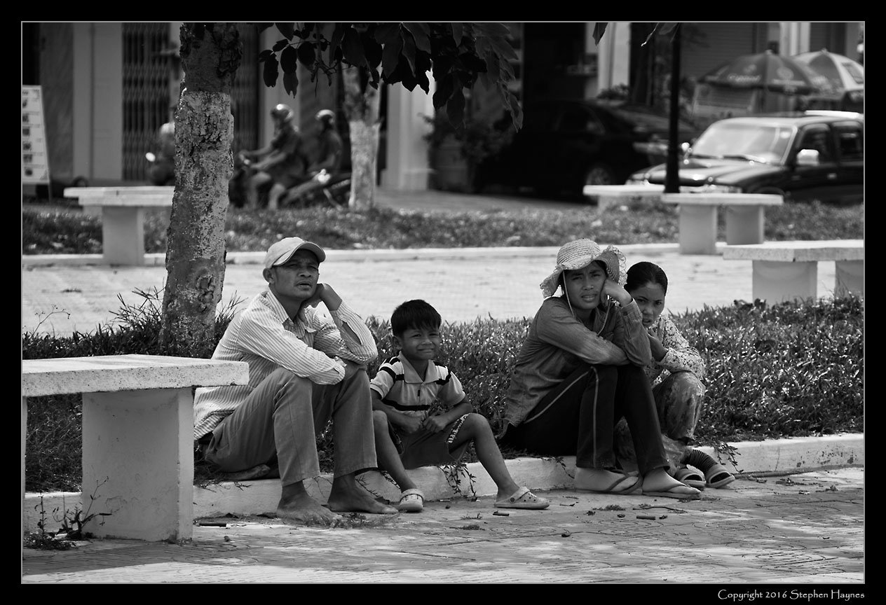 Kampot Town, On the road east from Sihanoukville, Cambodia --
Family watching the tourists.