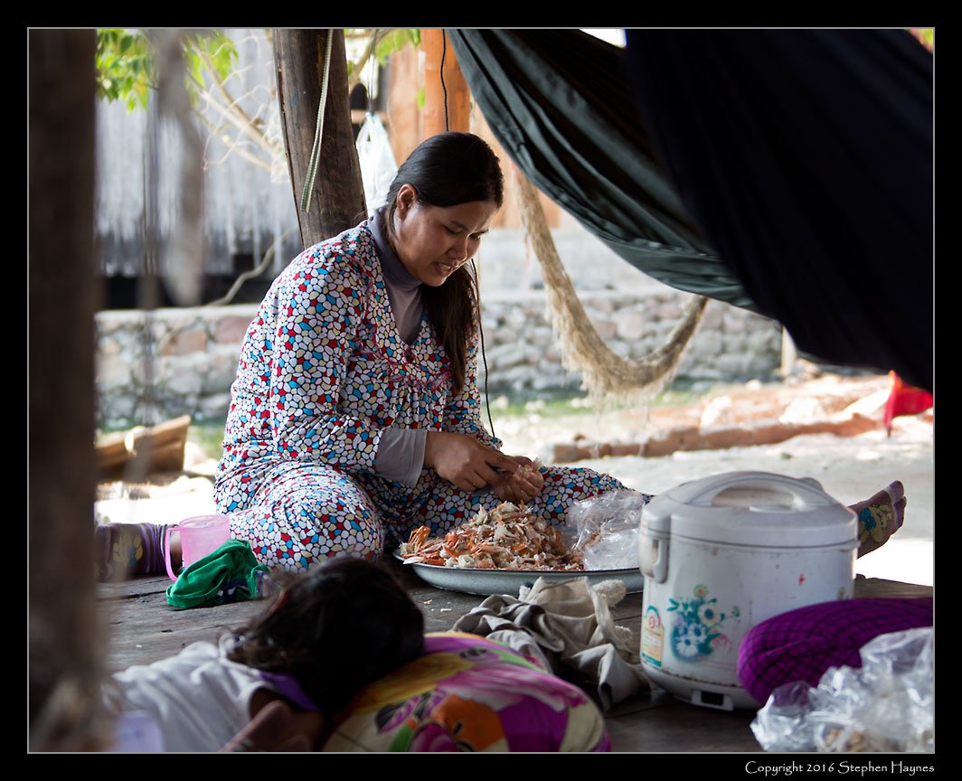 Ropang Ropov Fishing Village, On the road east from Sihanoukville, Cambodia --
Preparing the evening's meal (note the rice cooker).