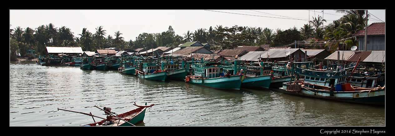 Ropang Ropov Fishing Village, On the road east from Sihanoukville, Cambodia --
Fishing boats lining the estuary (Gulf of Thailand just beyond, out of sight).