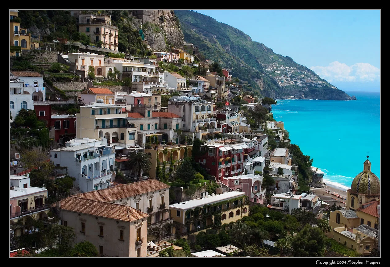 Positano -- 

(At lower right you see a portion of Positano's private beach,
which in addition to crashing surf provides sights of typical
European beach "attire" [i.e., nudity].)