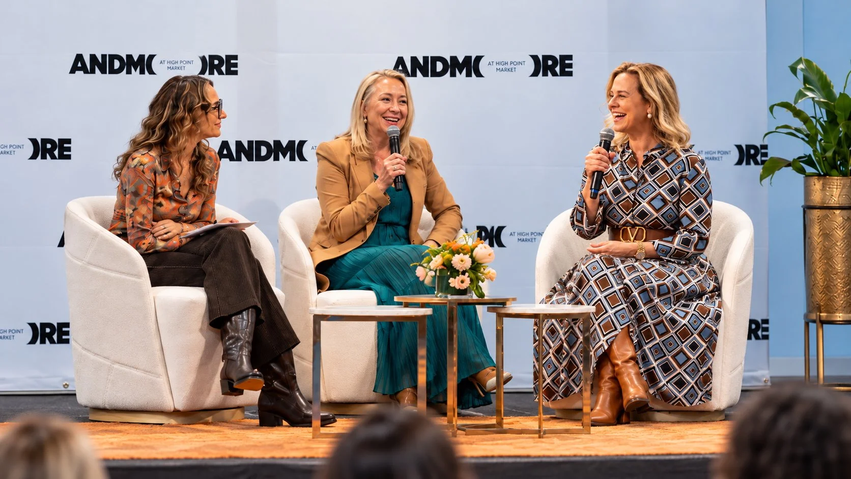 Patricia Kennedy and fellow panelists seated on stage during a panel discussion at ANDMORE Market