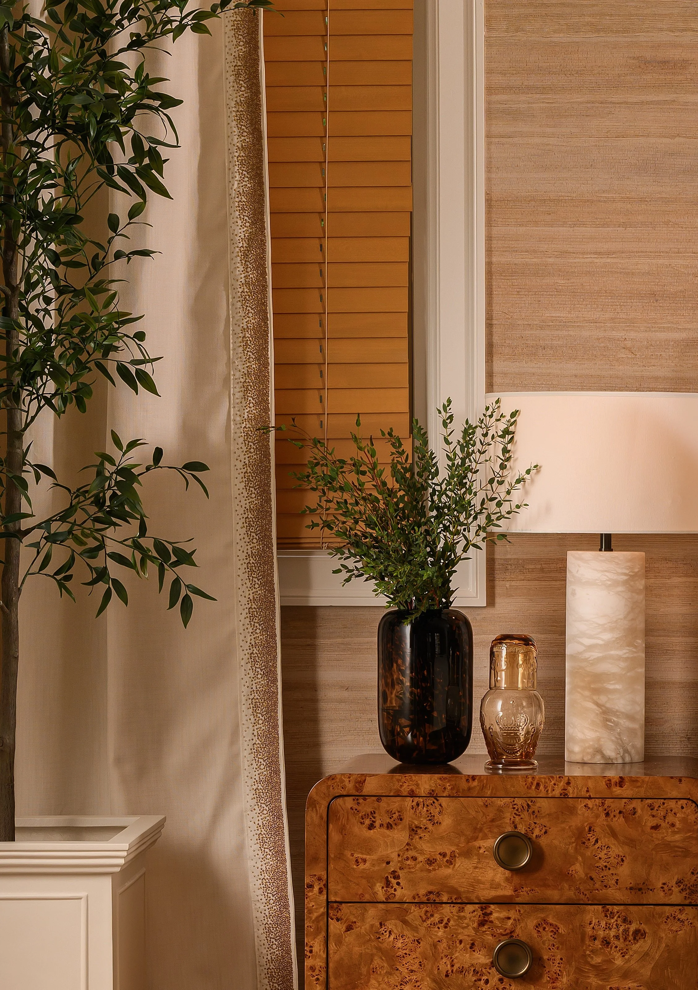 Quiet details of grasscloth, burled wood, alabaster, and seaspray trim