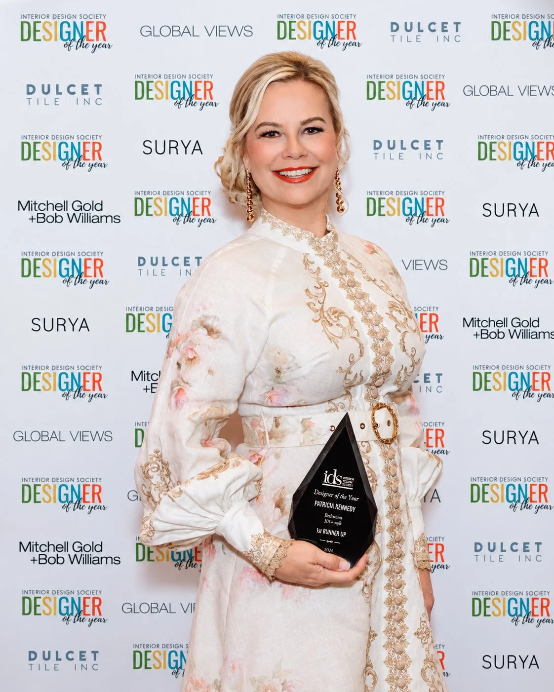 Patricia Kennedy holding her 2026 IDS Designer of the Year award for bedroom design