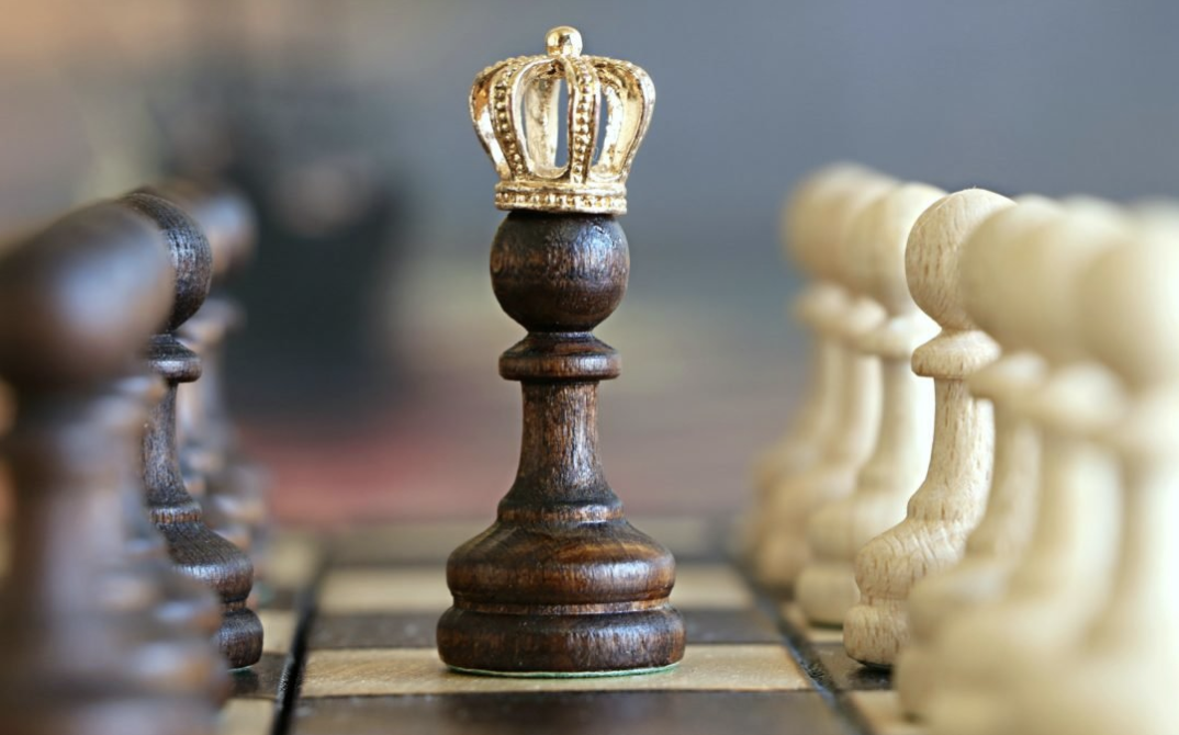 CliftonStrengths leadership concept showing a crowned chess king symbolizing strengths-based leadership and strategic thinking.
