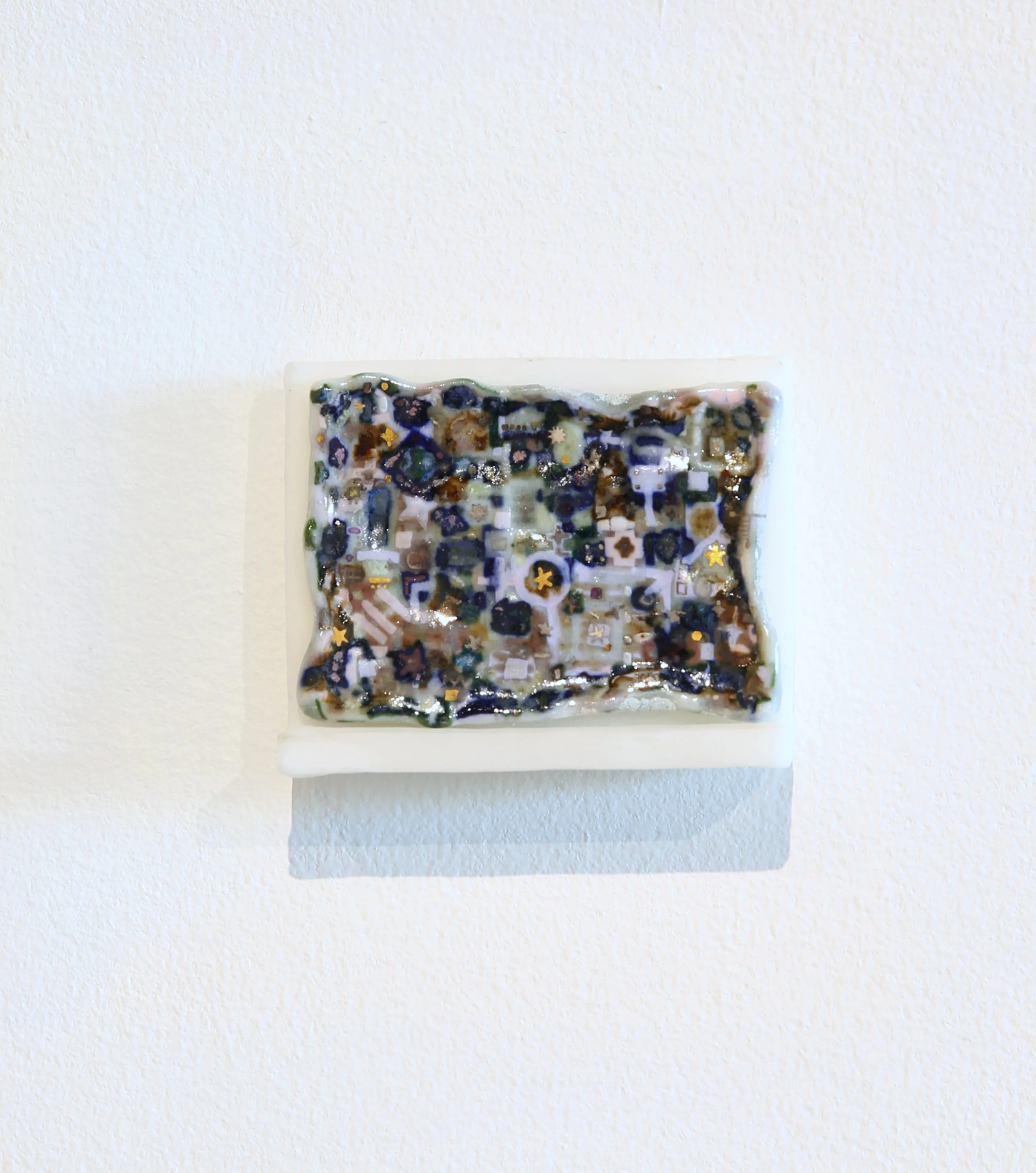 Trey Ross. 029 . 2026. Porcelain, glaze, overglaze, and urethane shelf. 3 x 2 inches.