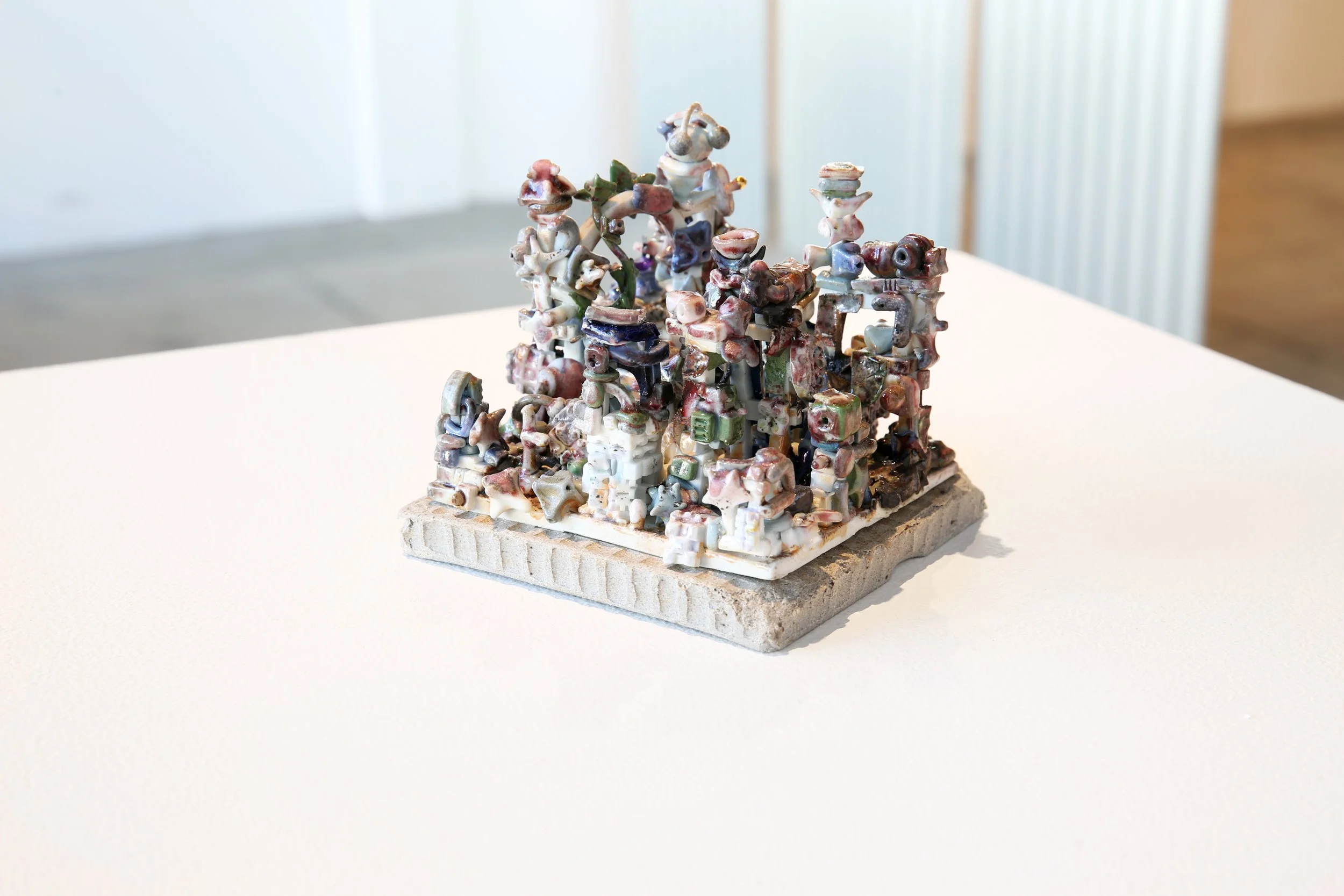 Trey Ross. 026 . 2026. Porcelain, glaze, overglaze, cubic zirconia, and stoneware platform. 5 x 5 x 5 inches (approximate).