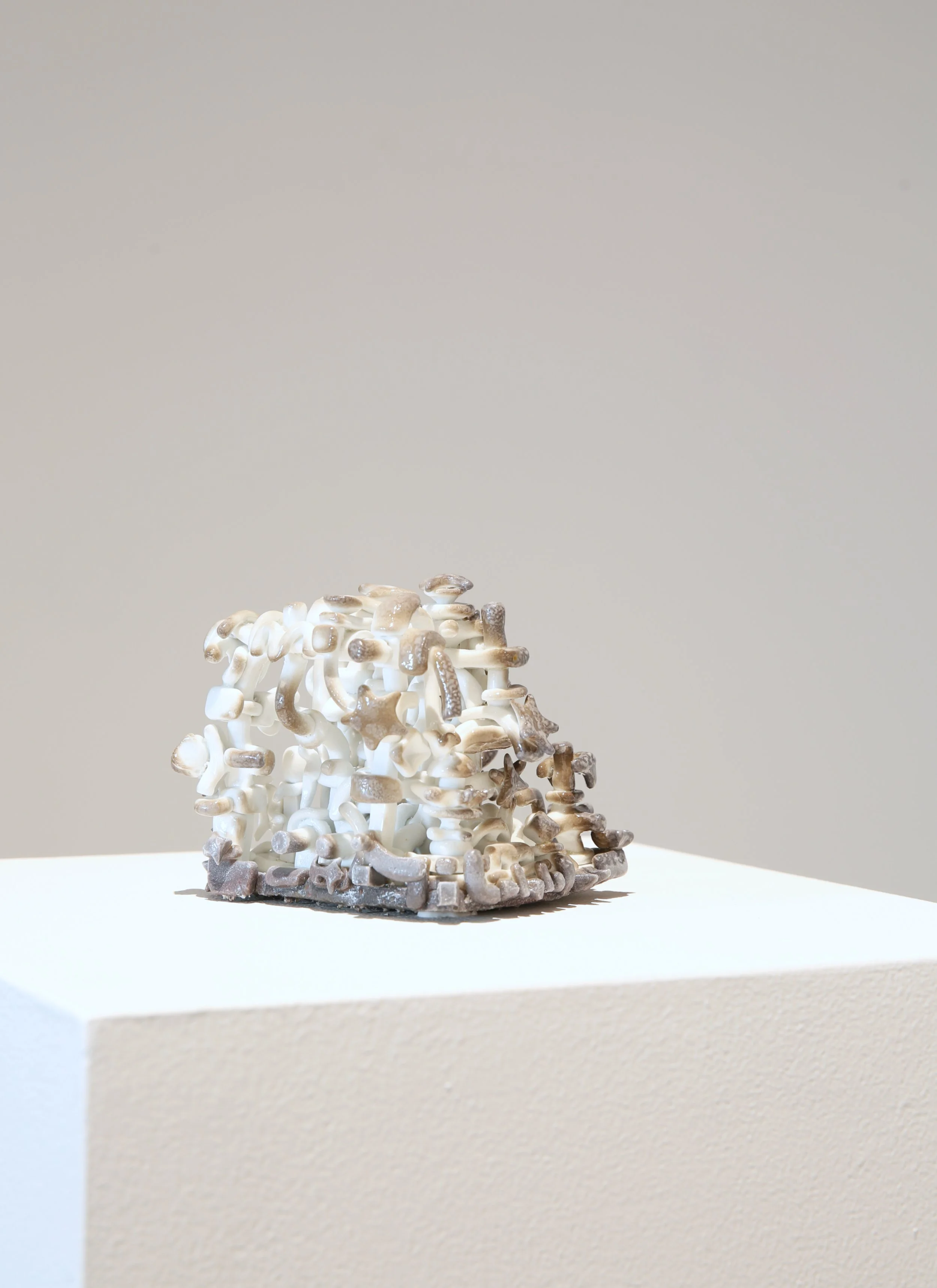 Trey Ross. 027 . 2026. Porcelain, glaze, and flashing slips. 4 x 4 x 4 inches (approximate).