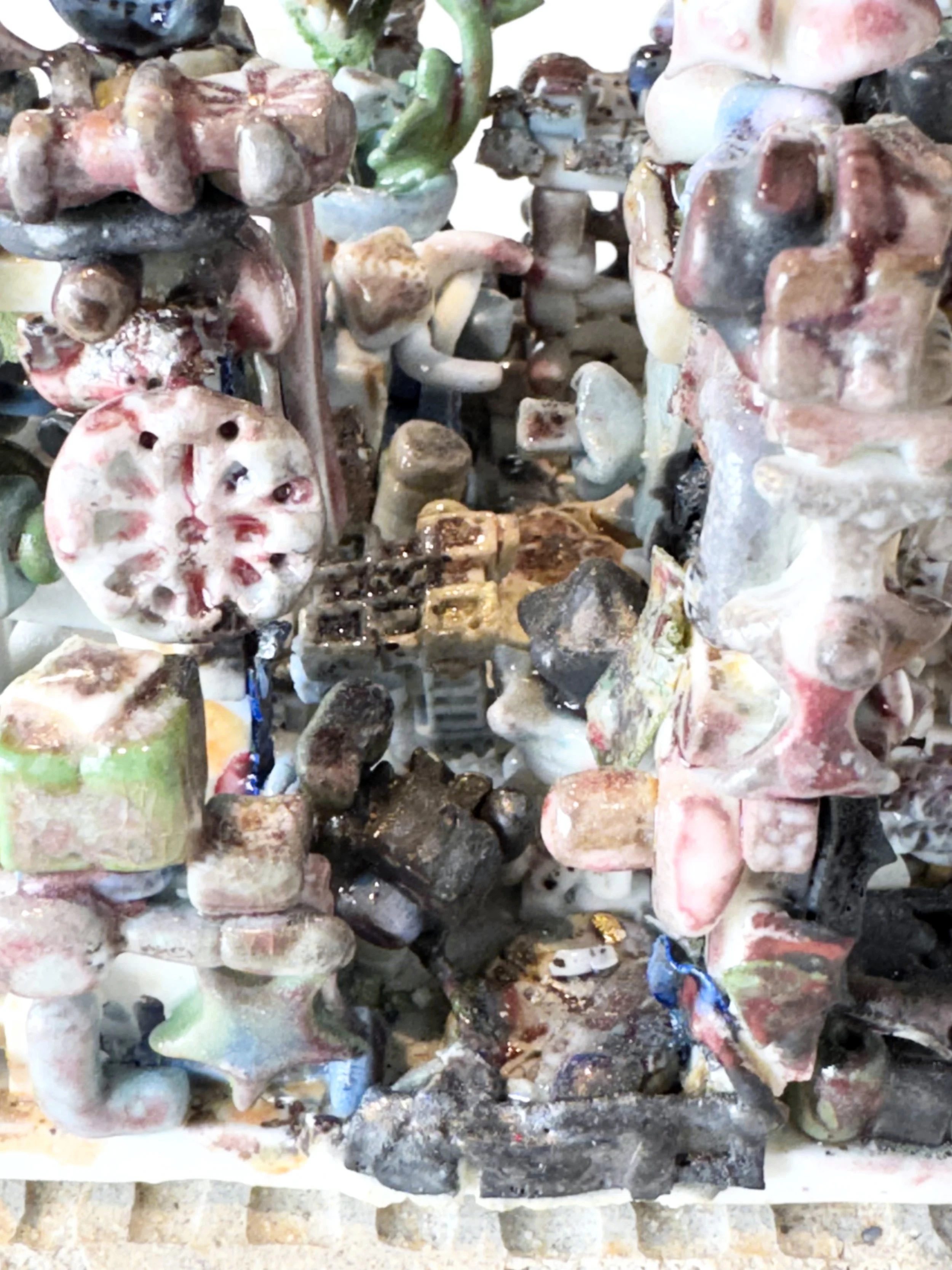 Trey Ross. 026 . 2026. Porcelain, glaze, overglaze, cubic zirconia, and stoneware platform. [Detail.]