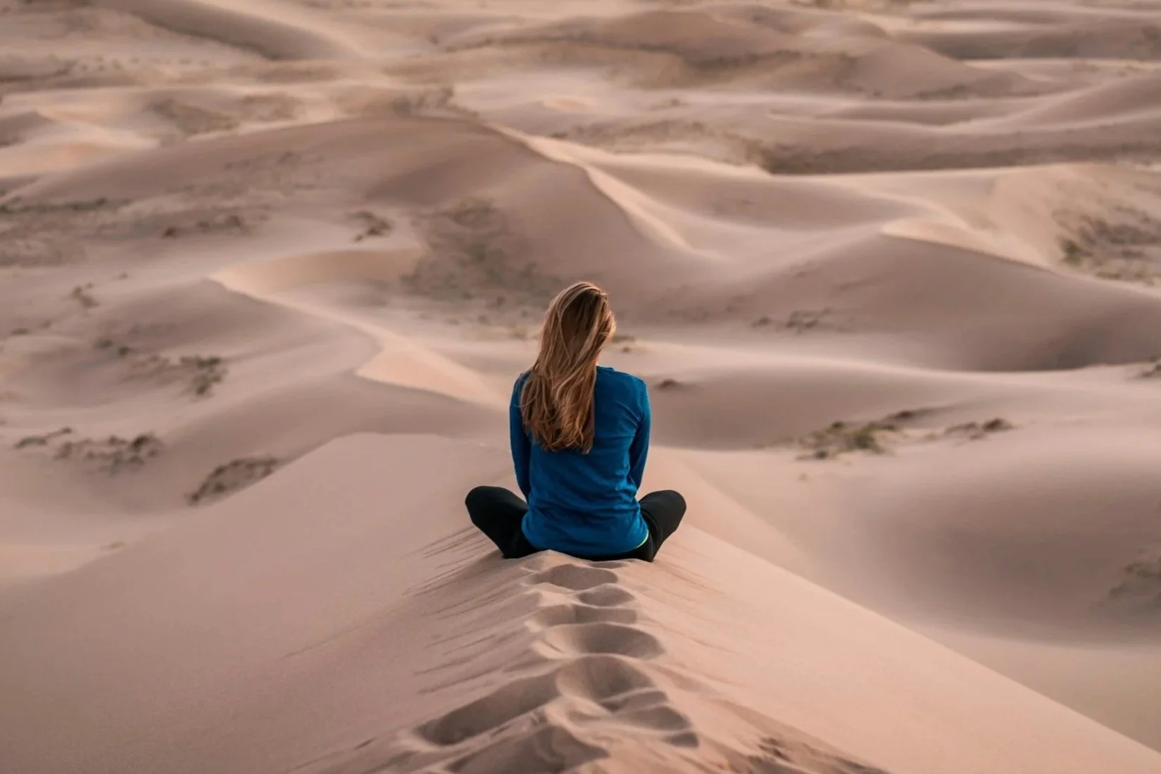 woman meditating in the desert
