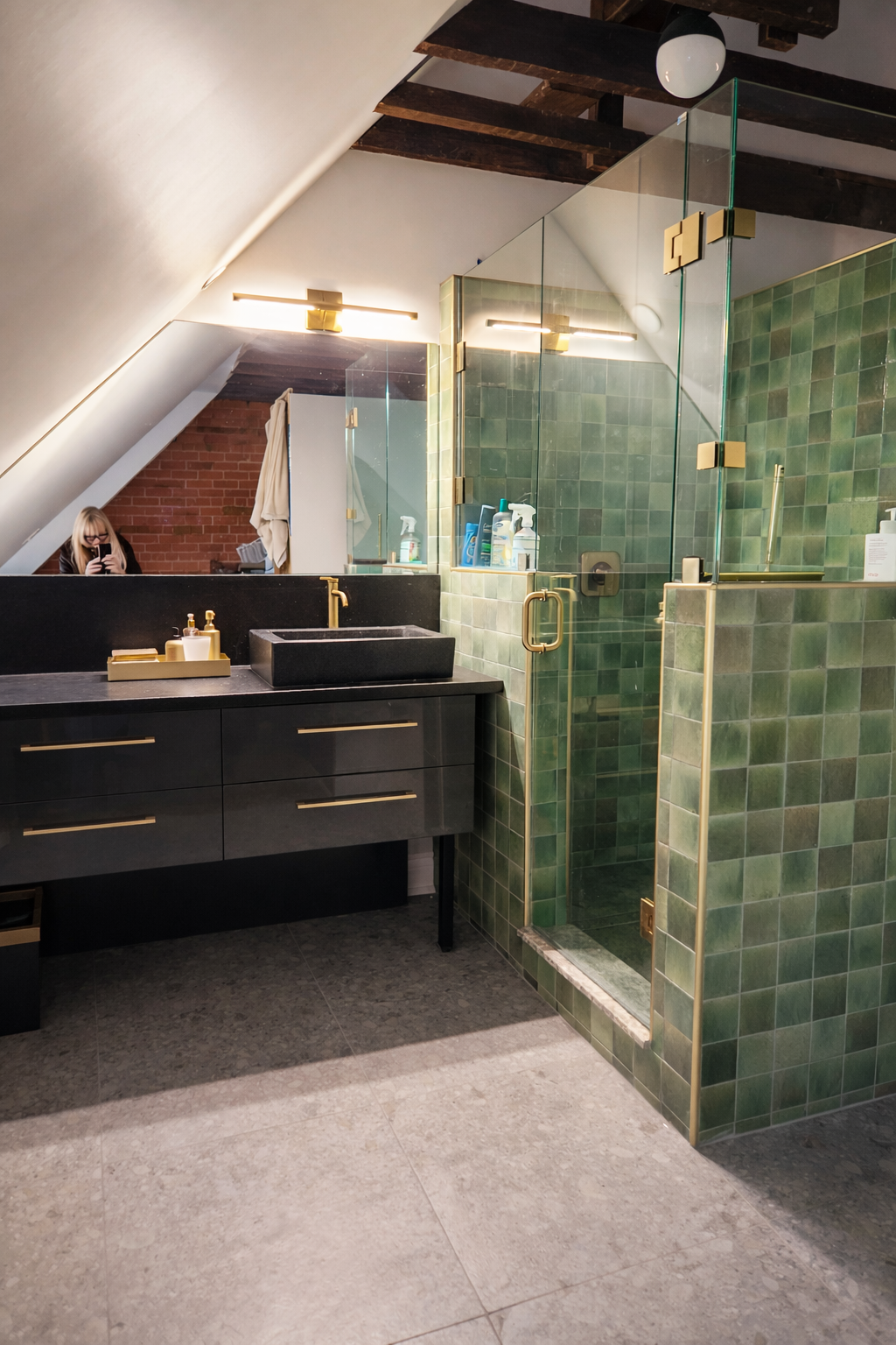 Modern attic bathroom with brass accents.png