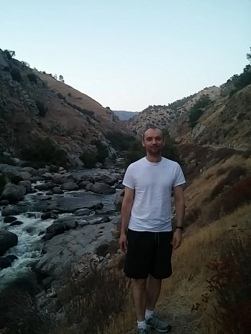 DustSolve Owner George hiking in canyon by rocky stream
