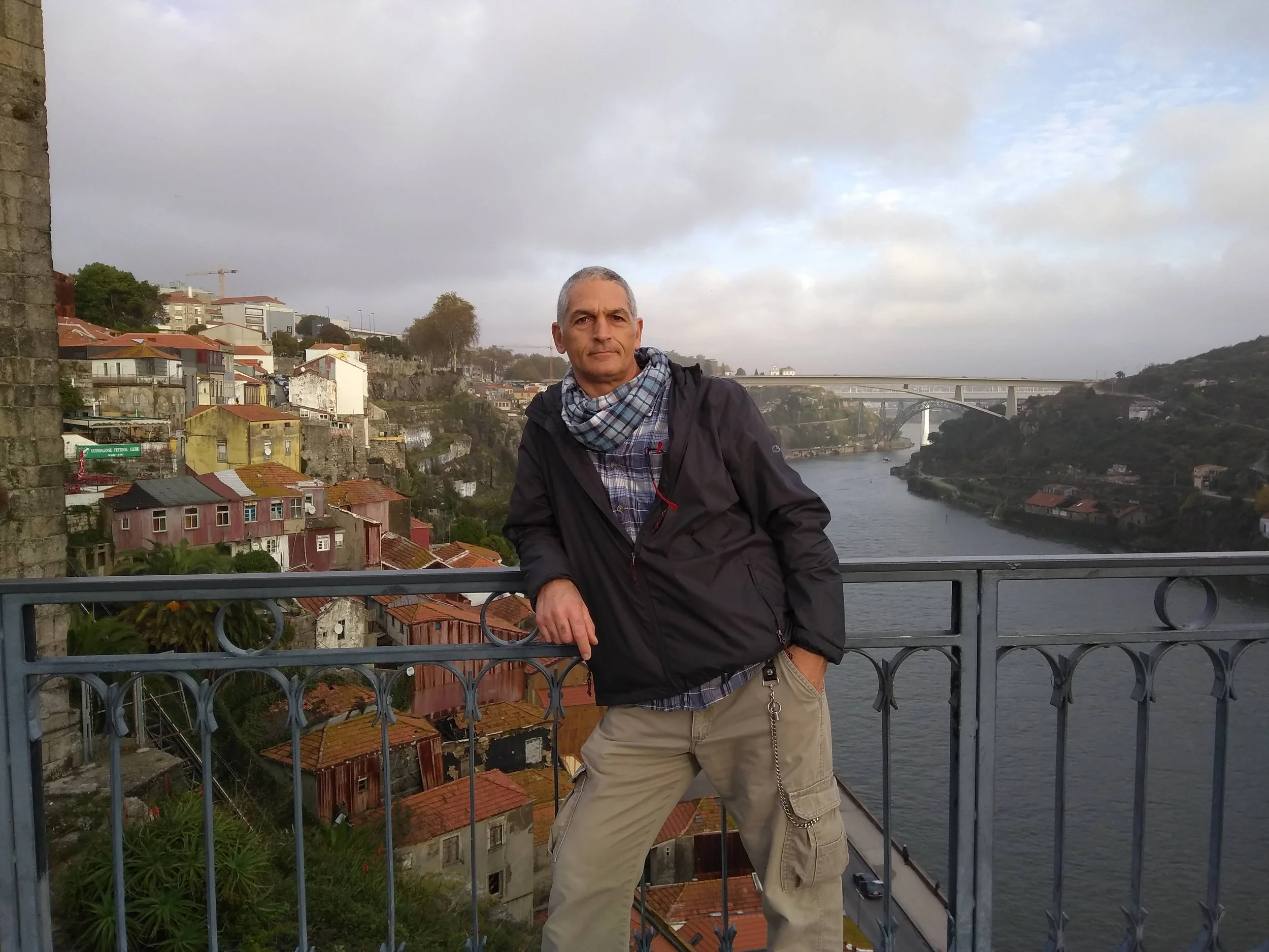 DustSolve owner Vic on balcony overlooking river and bridge