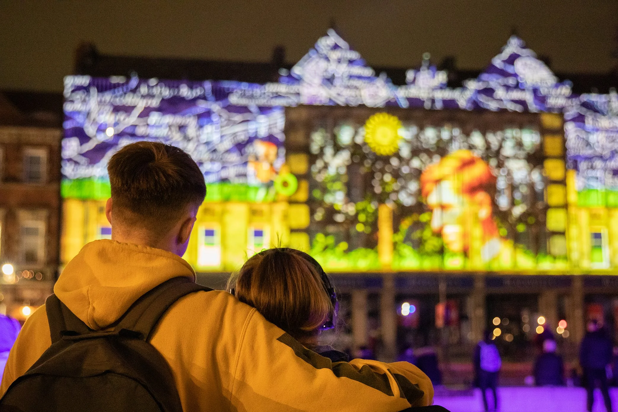 A couple watching Take Me to the River by imitating the dog at the festival finale