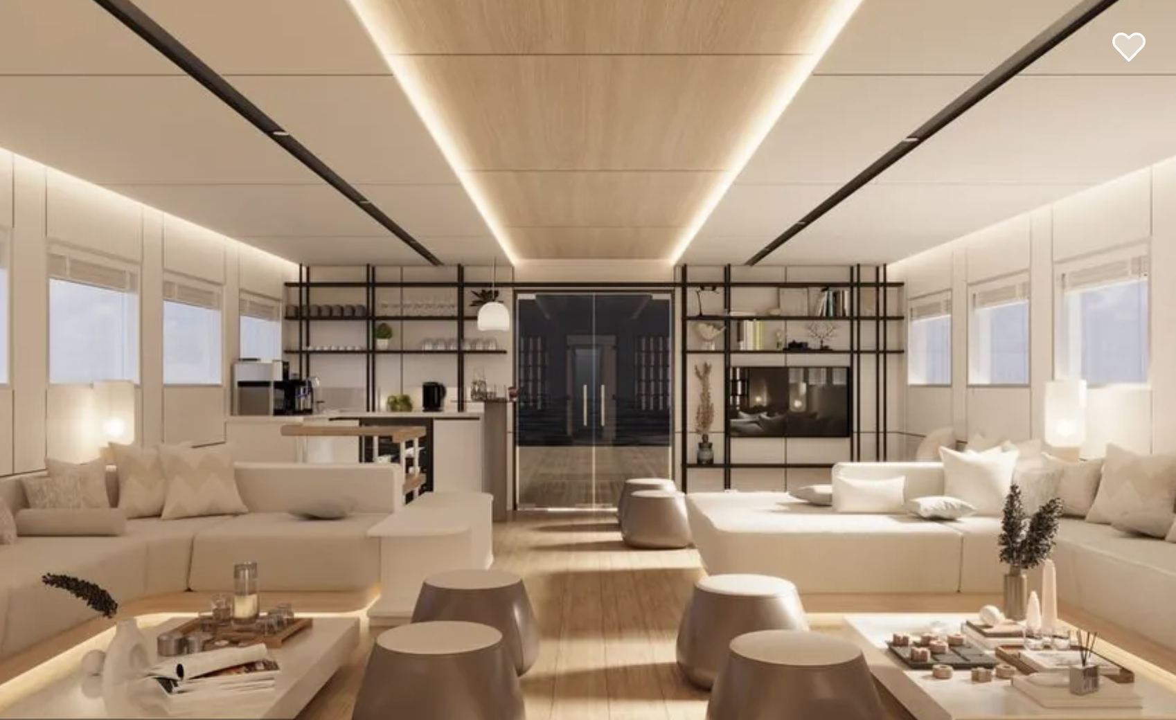 Spacious modern living room with white sofas, multiple windows, wooden flooring, open kitchen, and decorative shelves.