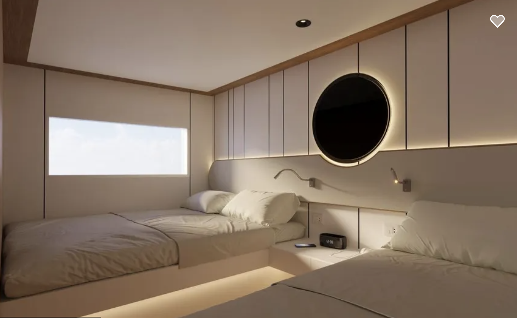 Modern bedroom with two beds, white bedding, a round black mirror with backlit ring on the wall, a window with daytime sky view, and small wall-mounted reading lights.