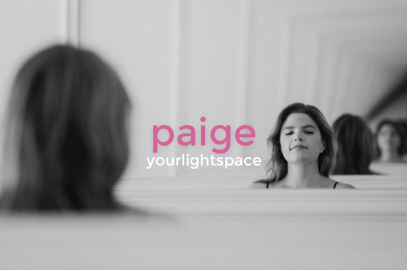 Black and white photo of a woman looking at her reflection in a mirror, with the text 'paige yourlightspace' overlaid in pink and white.