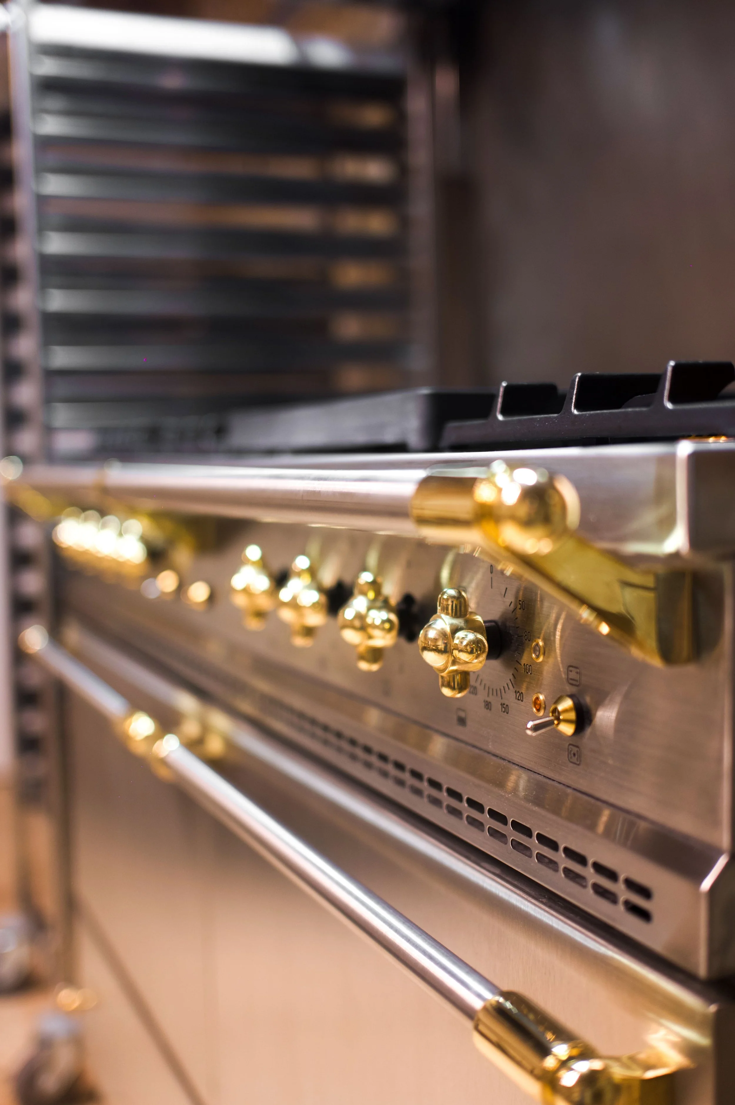 Stainless steel stove with gold control panels and gold knobs