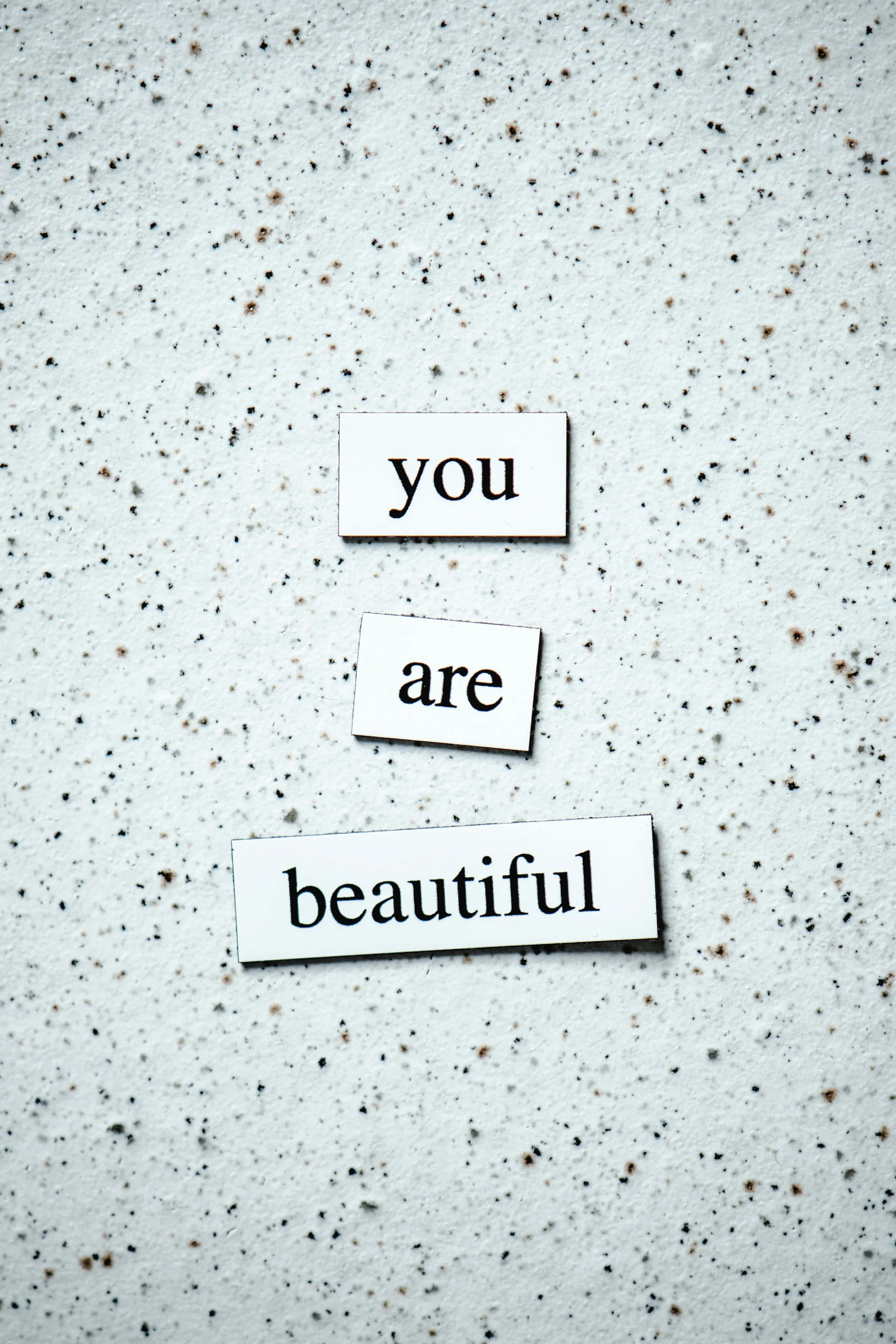 three magnets spelling out the words "you are beautiful"