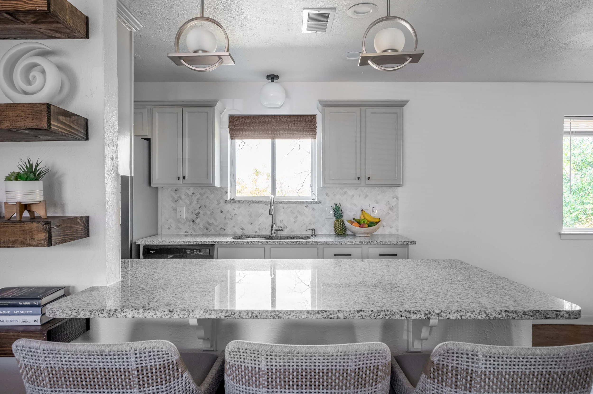 Updated galley kitchen with new flooring backsplash lighting and painted cabinets