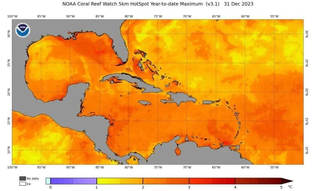 Map of the Caribbean and surrounding waters showing coral reef watch data with areas colored in shades of red and orange indicating high sea surface temperatures as of December 31, 2023, with no ice or data in gray and blue.