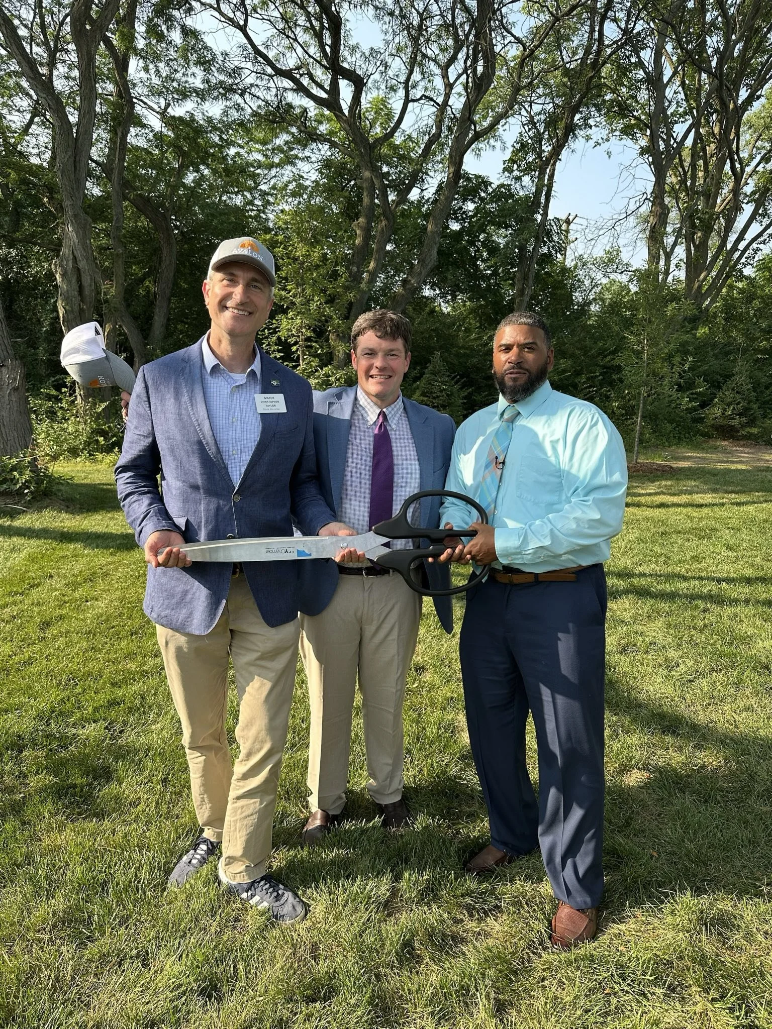 Mayor Taylor and others with giant scissors.