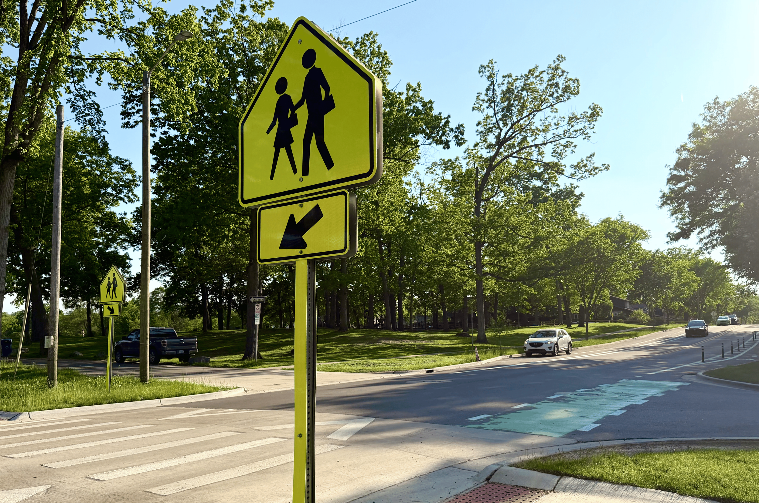 An image of Pauline Road, with a pedestrian crossing and newly repaved street