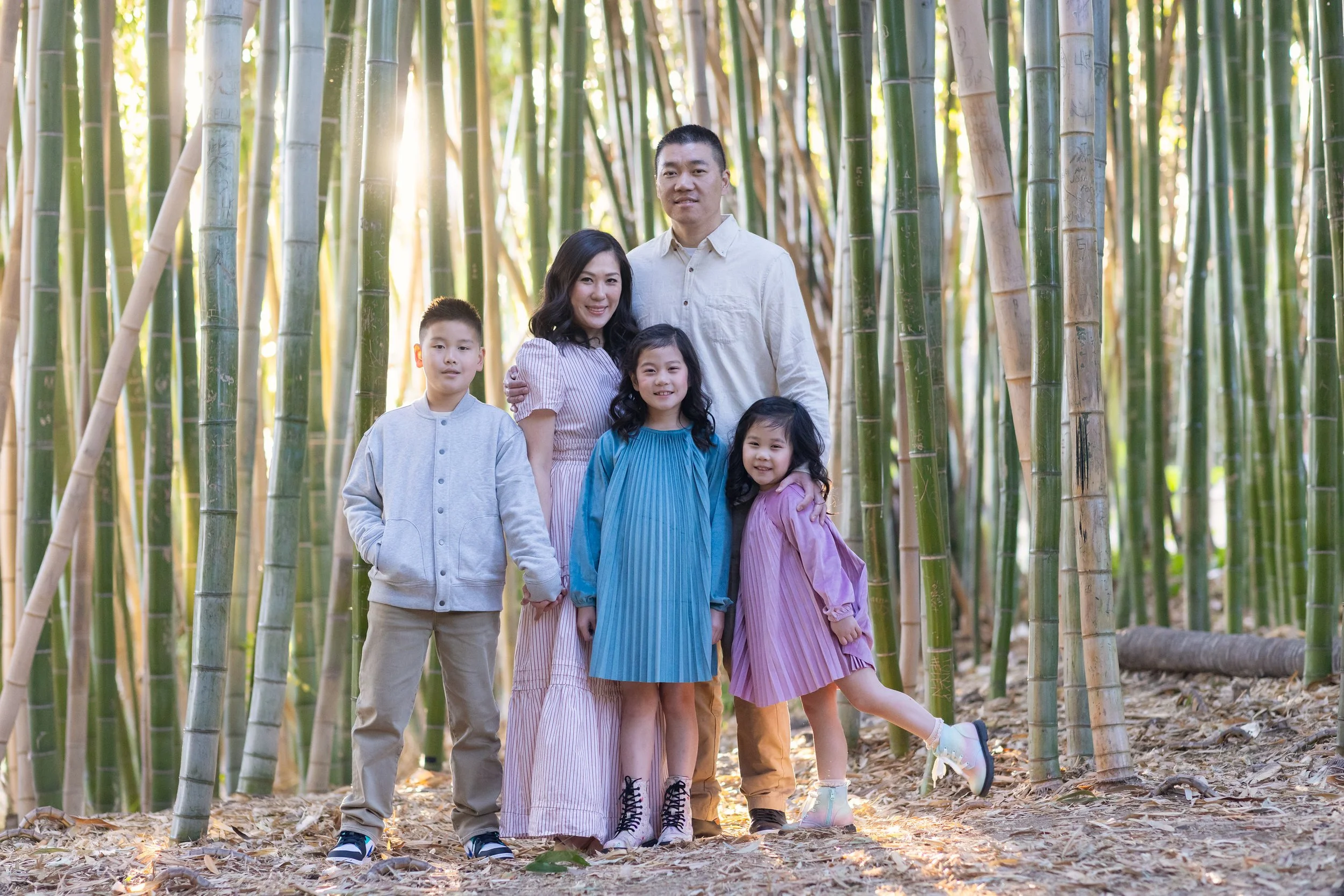 A Family of 5 in a bamboo garden at sunset