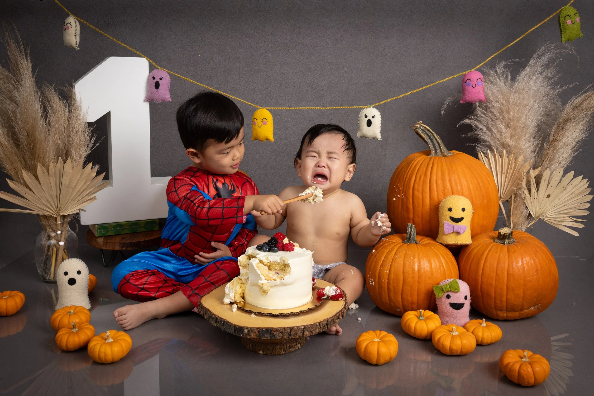 Crying-baby-boy-cake-smash-halloween-spiderman.jpg