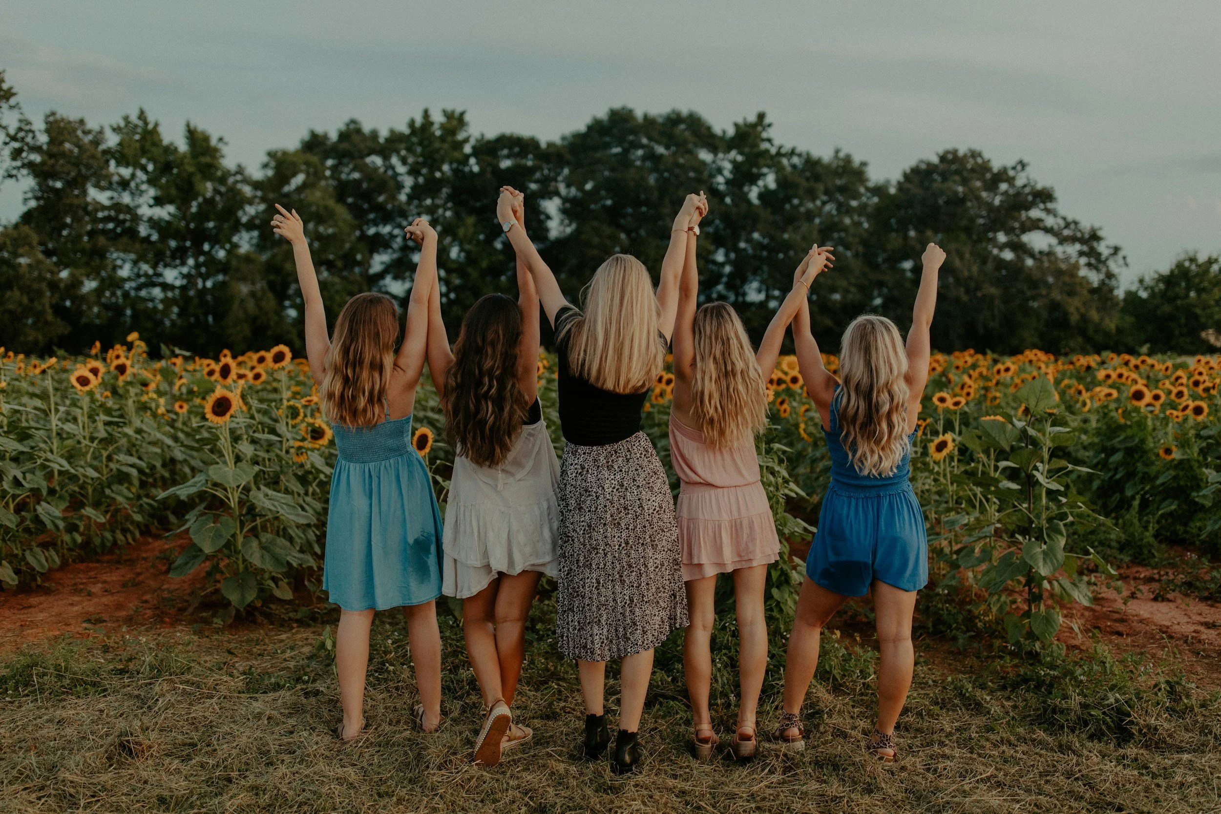 Christian-friendship-friends-walking-through-sunflower-field