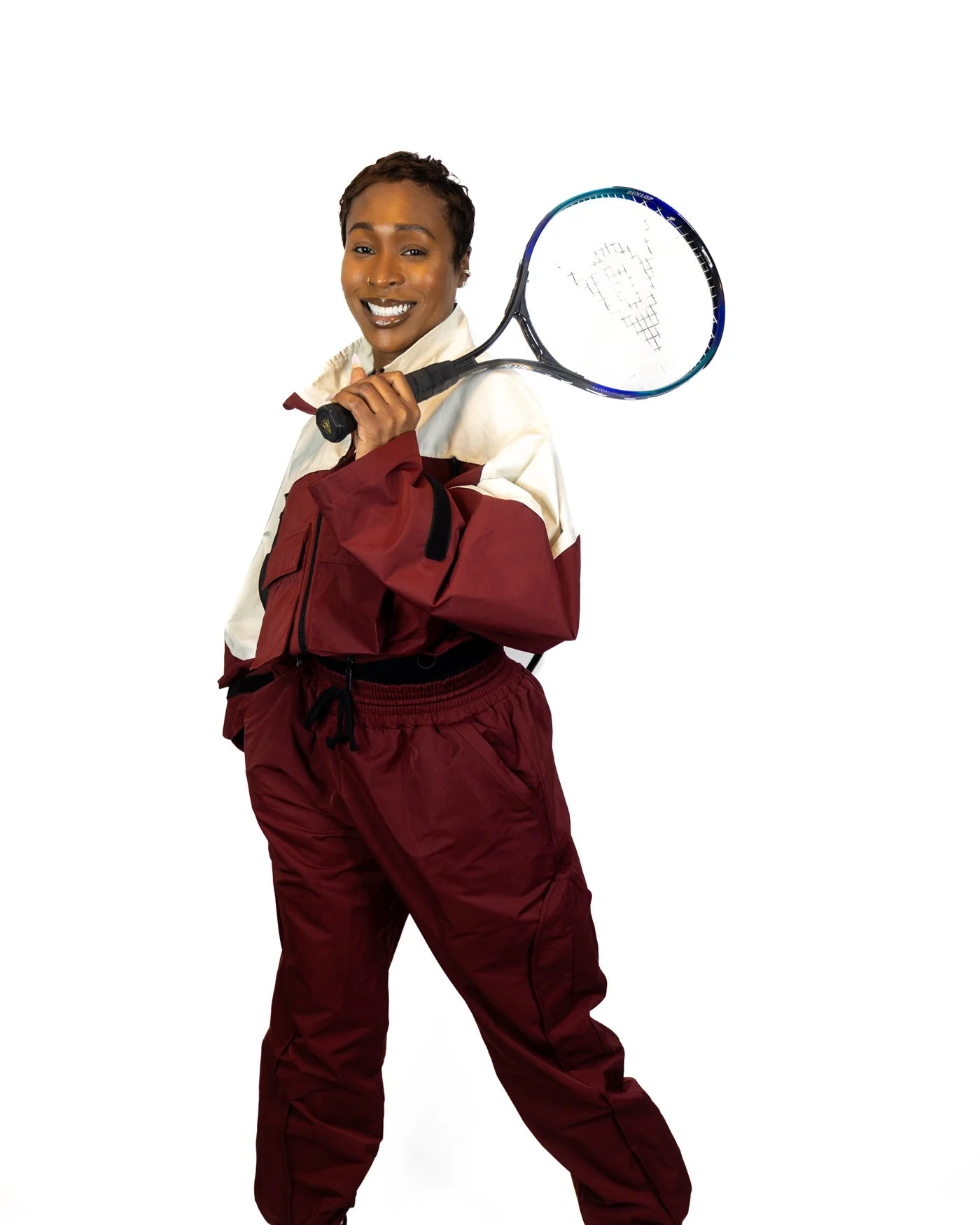 Professional posing with a tennis racket during a personal branding photography session.